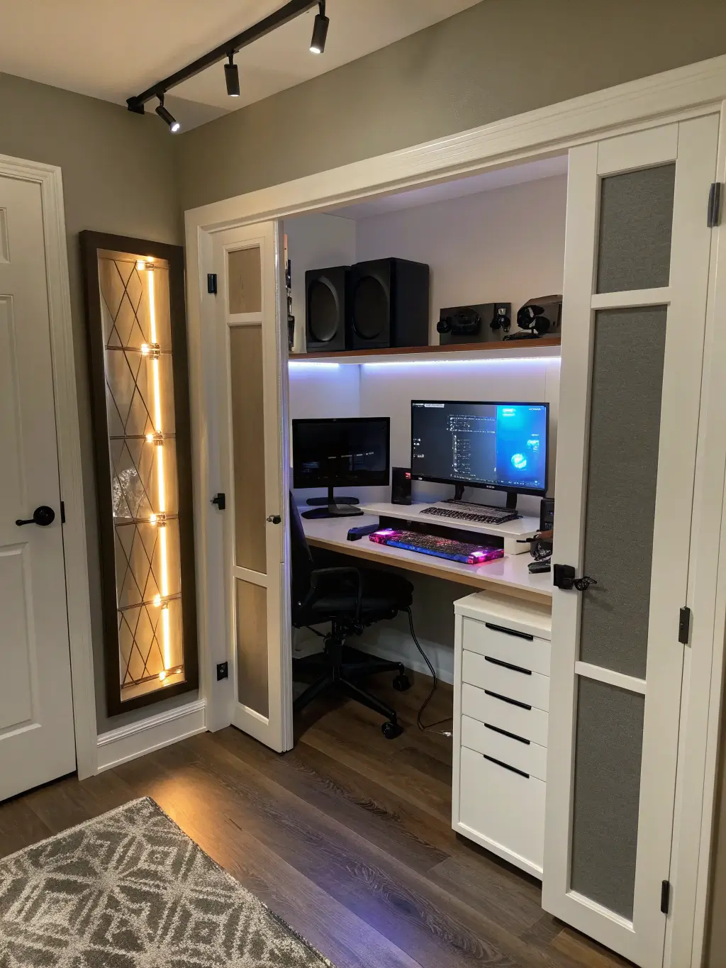 Compact gaming and productivity home office setup with transforming desk, hidden PC compartment, art-inspired acoustic panels, and warm white lighting with RGB accents in an 8' x 10' space-efficient room.